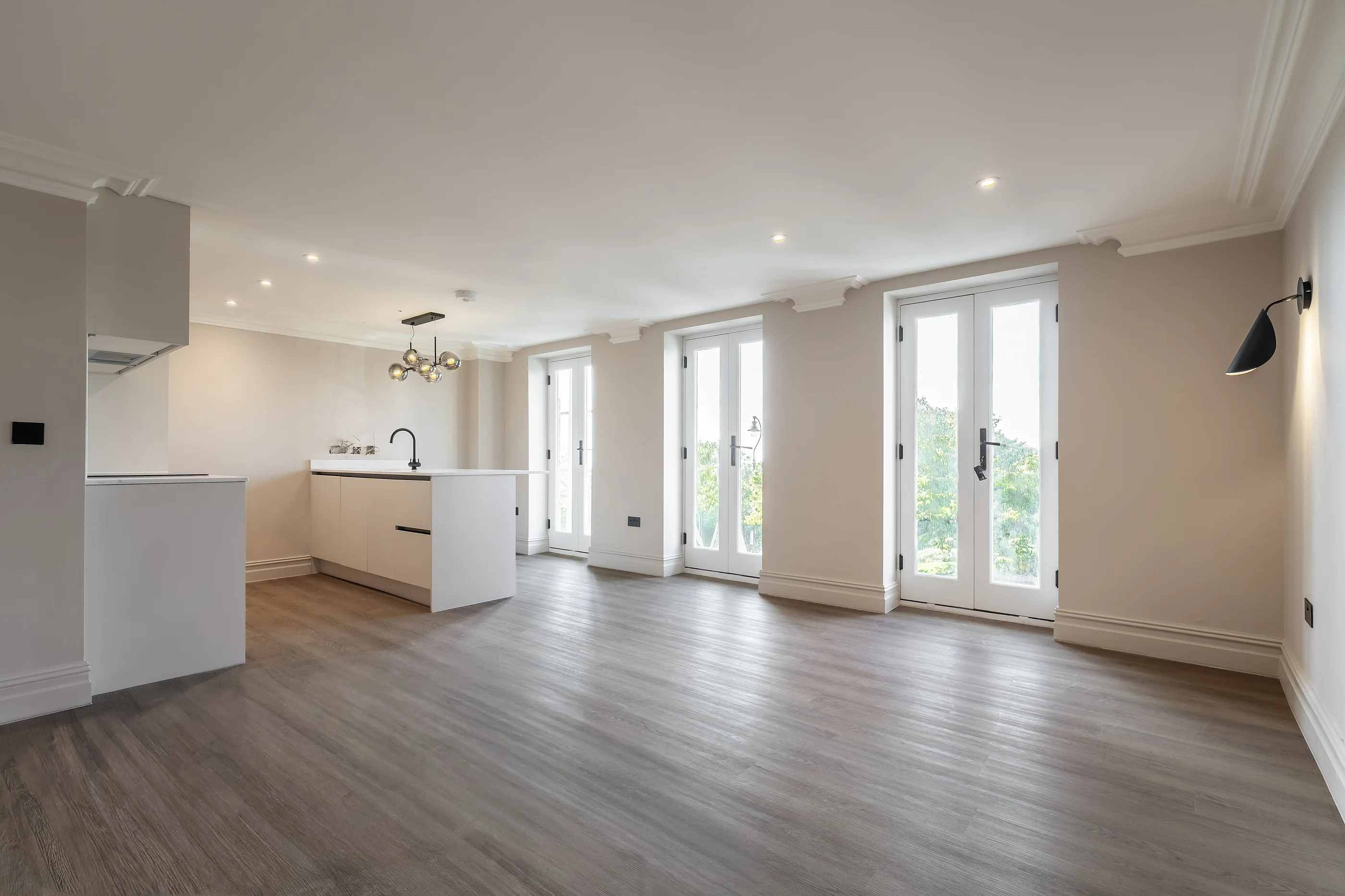 Open-plan kitchen and living space with French doors